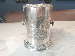 An Antique Silver Plated Wine Bottle Holder With Engraved/embossed Patterns.