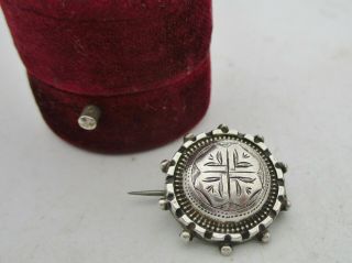 An Antique Victorian Era Sterling Silver Etruscan Revival Button Brooch.
