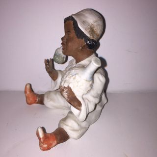 Antique Black Americana Bisque Figurine Of A Black Boy Sitting On The Ground. 2