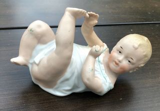 Antique Gebruder Heubach German Bisque Porcelain Piano Baby Figurine 5” Long