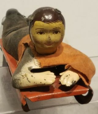 Antique Tin Litho Boy On Sled Tin Toy.  NR 2