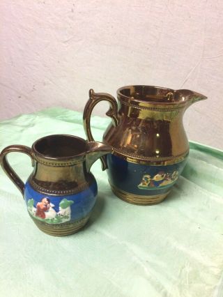 Copper Lustre Jugs With Relief Molded Figures Beaded Bands