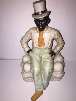 Black Americana Well Dressed Black Man Sitting On A Bale Of Cotton.  Bisque.  Rare