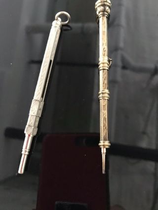 Antique Pencil Holders: One Is Sterling Silver The Other Has A Red Srone On End.