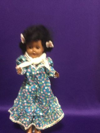 Unbranded African American Doll,  11 Inches Tall.  Green Dress.  Strung.