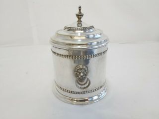 An Antique Silver Plated Biscuit Barrel With Embossed Lions Faces.  Rare.  M&co.