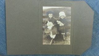 Antique Photo 2 Girls Holding Porcelain Head Dolls,  High Buttoned Shoes,  Folder