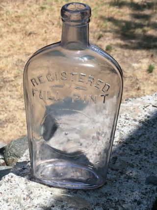 Antique Registered Full Pint Strap Side Whiskey Flask.  Sun Purple Glass Bottle