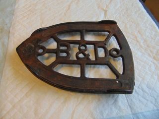 Antique B & D Sad Iron Trivet,  3 feet,  cast iron,  4 1/4 