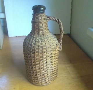 Wicker Covered 1890s Hand Blown Olive Green Liquor Bottle With Handle