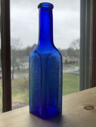 Laxol A J White.  York Embossed Glass Bottle Cobalt Blue - Patented 1894
