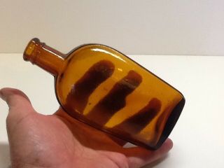 Antique Amber Half Pint Strap Side Whiskey Flask.  F Embossed On Bottom.