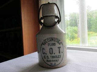 C.  O.  T Vulcanizing Fluid C.  O.  Thigley Rahway N.  J.  Stoneware Bottle With Wire Bail