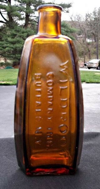 Wildroot Company Inc.  Buffalo N.  Y.  Light Amber Corker Hair Tonic Bottle
