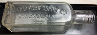 Undertaker’s Supply Co.  Chicago,  Ill.  6 5/8” Embossed Glass Bottle