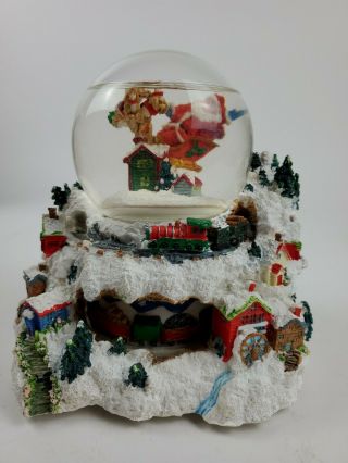 Santa Flying Over Village Snow Globe Music Box With Moving Train