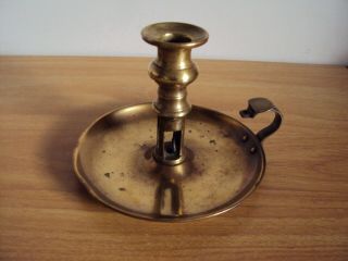 An Antique Brass Candlestick With Incomplete Mechanism To Push Out Candles