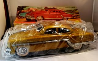 Antique Minister Deluxe Gold Tin Friction Car In.