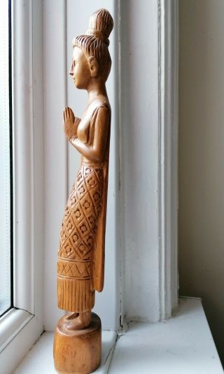 Antique wooden statue of a Thai lady. 2