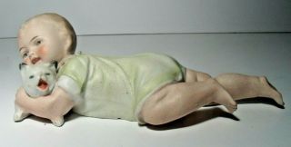 German Bisque Piano Baby,  Holding Dog