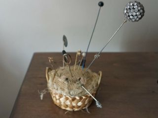 Antique Basket Style Pin Cushion With A Variety Of Hat Pins