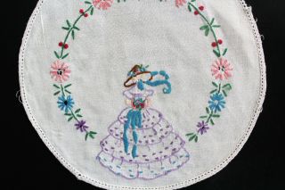 Vintage white round doily with hand embroidered crinoline lady and flowers. 2