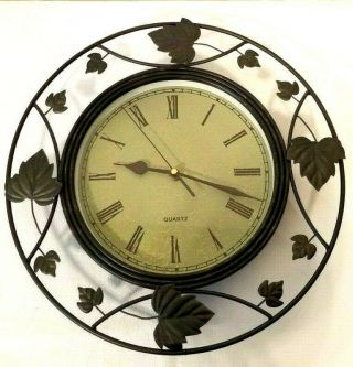 Roman Numeral Quartz Wall Clock Set In Round Leaf Design Metal Frame