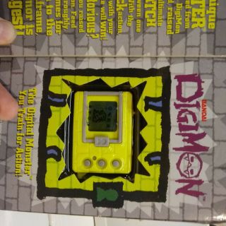 1997 Bandai Digimon Tamagotchi Yellow Rare Never Been Opened.  Natural Wear Pkg
