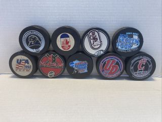 9 Assorted College / Minor League Hockey Pucks And Worn (puck 1)