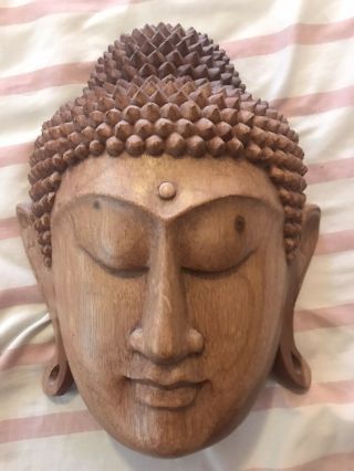 Carved Wooden Buddha Head Height 8 1/2”,  Width 7”,  Thickness 3 1/2”