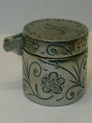 A Pewter Thimble Case With A Matching Thimble Marked On Top With The Letter " N "