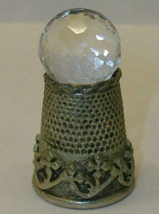 A Pewter Thimble Set With A Large Crystel On Top
