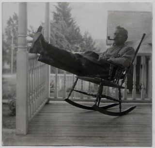 Old Photo Man Sitting In Rocking Chair Smoking Pipe On Porch 1920s