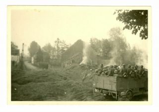 German Soldiers In Truck Advancing Through Village.  Ww2 Photo