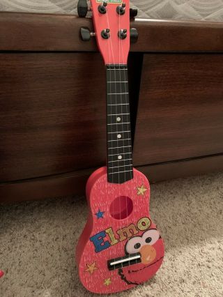 Elmo String Guitar.  First Act 4 String.  No Flaws.  20” Long.  Sesame Street.